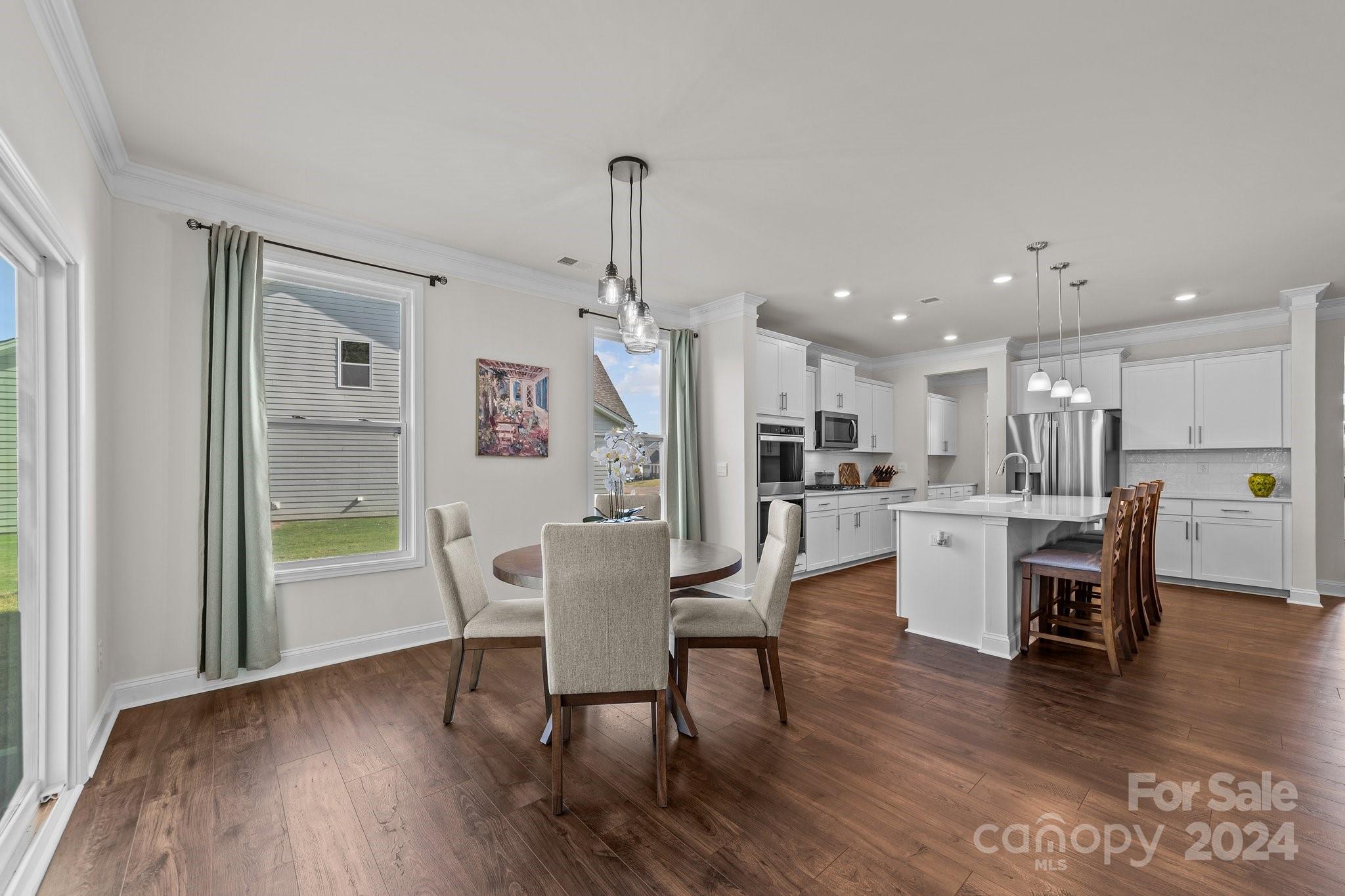 6037 Treehouse Drive Charlotte, NC 28214 - Photo 16 of 48 a dining room with furniture and wooden floor