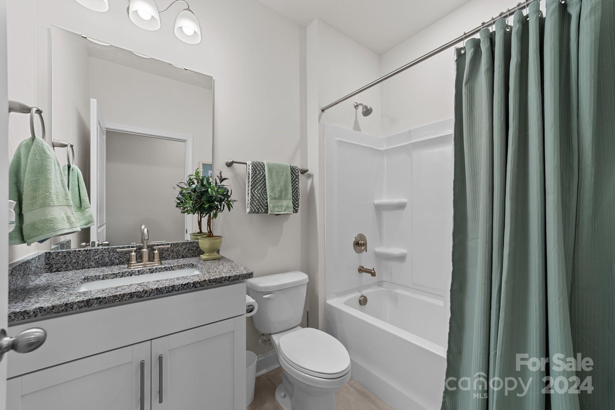 6037 Treehouse Drive Charlotte, NC 28214 - Photo 19 of 48 a bathroom with a granite countertop sink toilet and shower