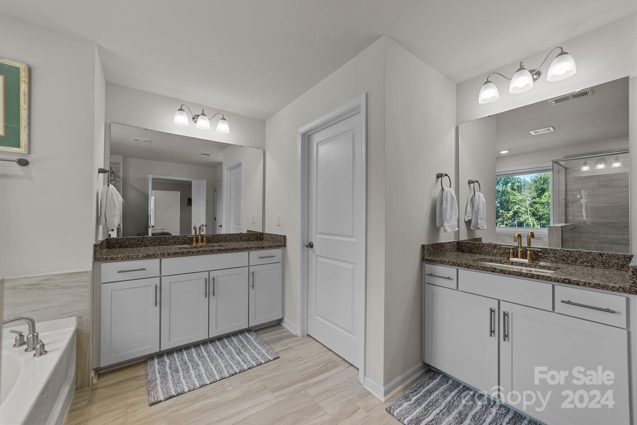 6037 Treehouse Drive Charlotte, NC 28214 - Photo 27 of 48 a bathroom with double sink and a mirror