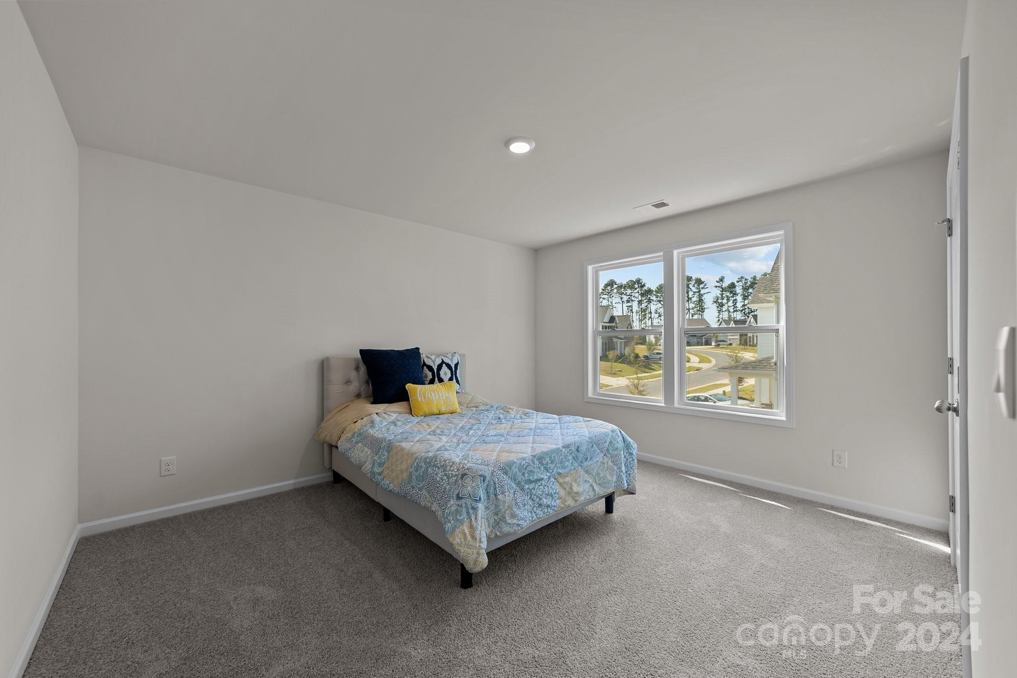 6037 Treehouse Drive Charlotte, NC 28214 - Photo 31 of 48 a bedroom with a bed and a window