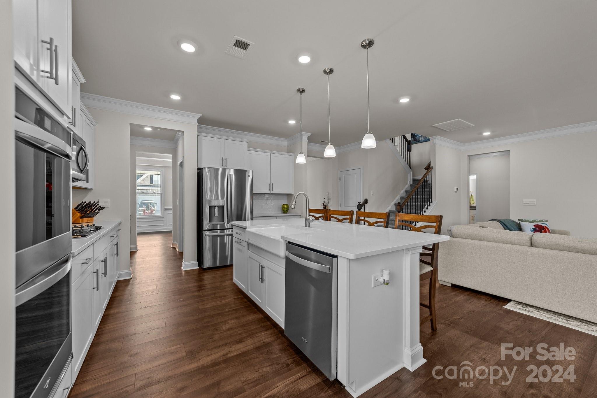 6037 Treehouse Drive Charlotte, NC 28214 - Photo 10 of 48 a large kitchen with stainless steel appliances kitchen island a large counter top and a refrigerator