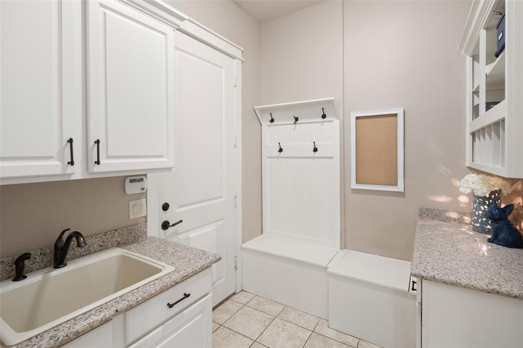 1814 Stacy Road Fairview, TX 75069 - Photo 16 of 33 Perfectly situated between garage entry and kitchen; upper and lower cabinets; storage bin & sink; separate oversized walk-in panty