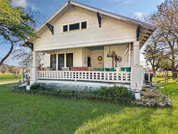 a front view of a house with a garden and deck