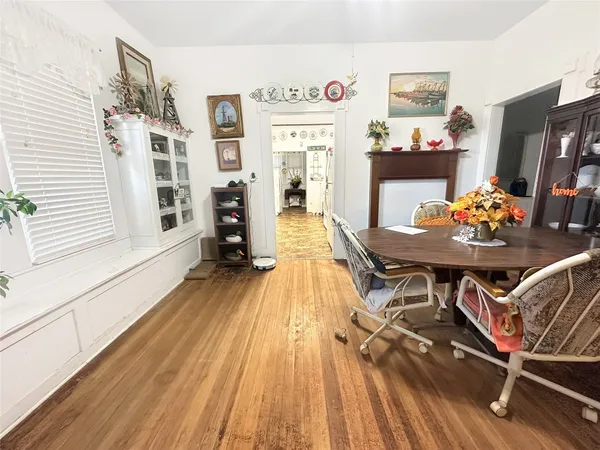 a dining room with furniture and wooden floor
