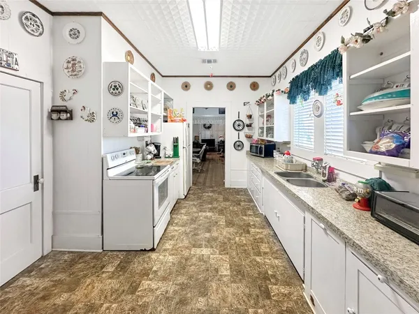 a kitchen with stainless steel appliances granite countertop a lot of counter top space and cabinets