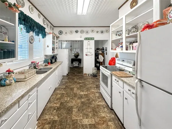 a kitchen with stainless steel appliances sink and cabinets