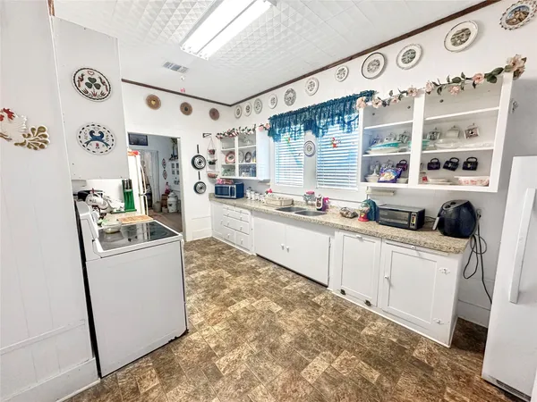 a kitchen with stainless steel appliances a stove a sink and a refrigerator
