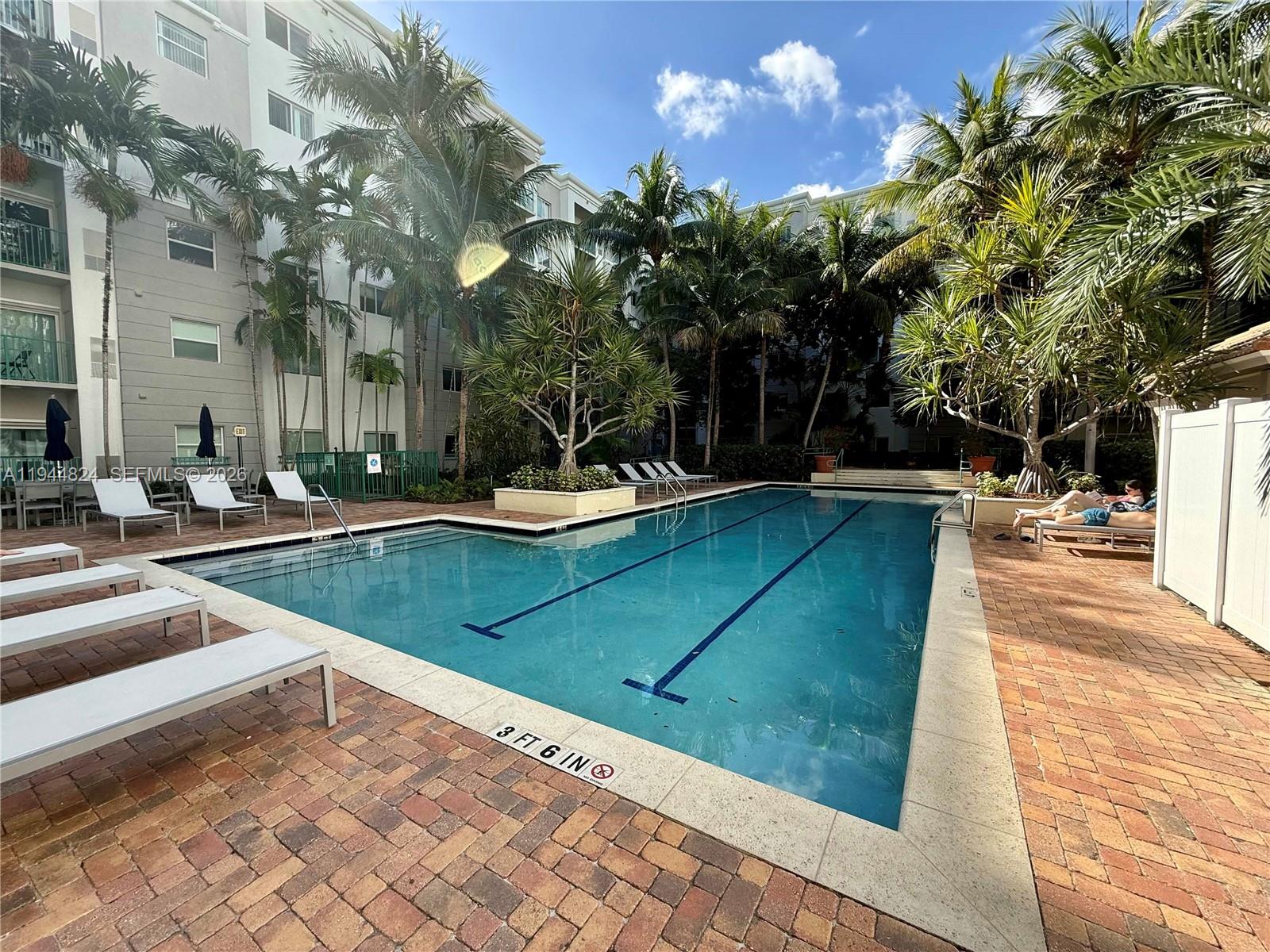 6001 Southwest 70th Street, Unit 612 South Miami, FL 33143 - Photo 15 of 20 a view of a swimming pool with lounge chair