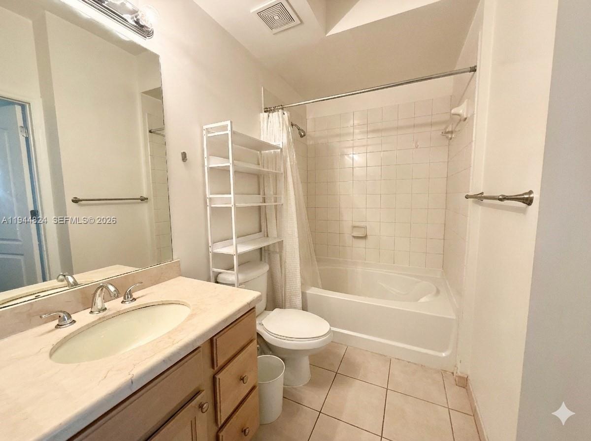 6001 Southwest 70th Street, Unit 612 South Miami, FL 33143 - Photo 10 of 20 a bathroom with a sink a toilet and shower