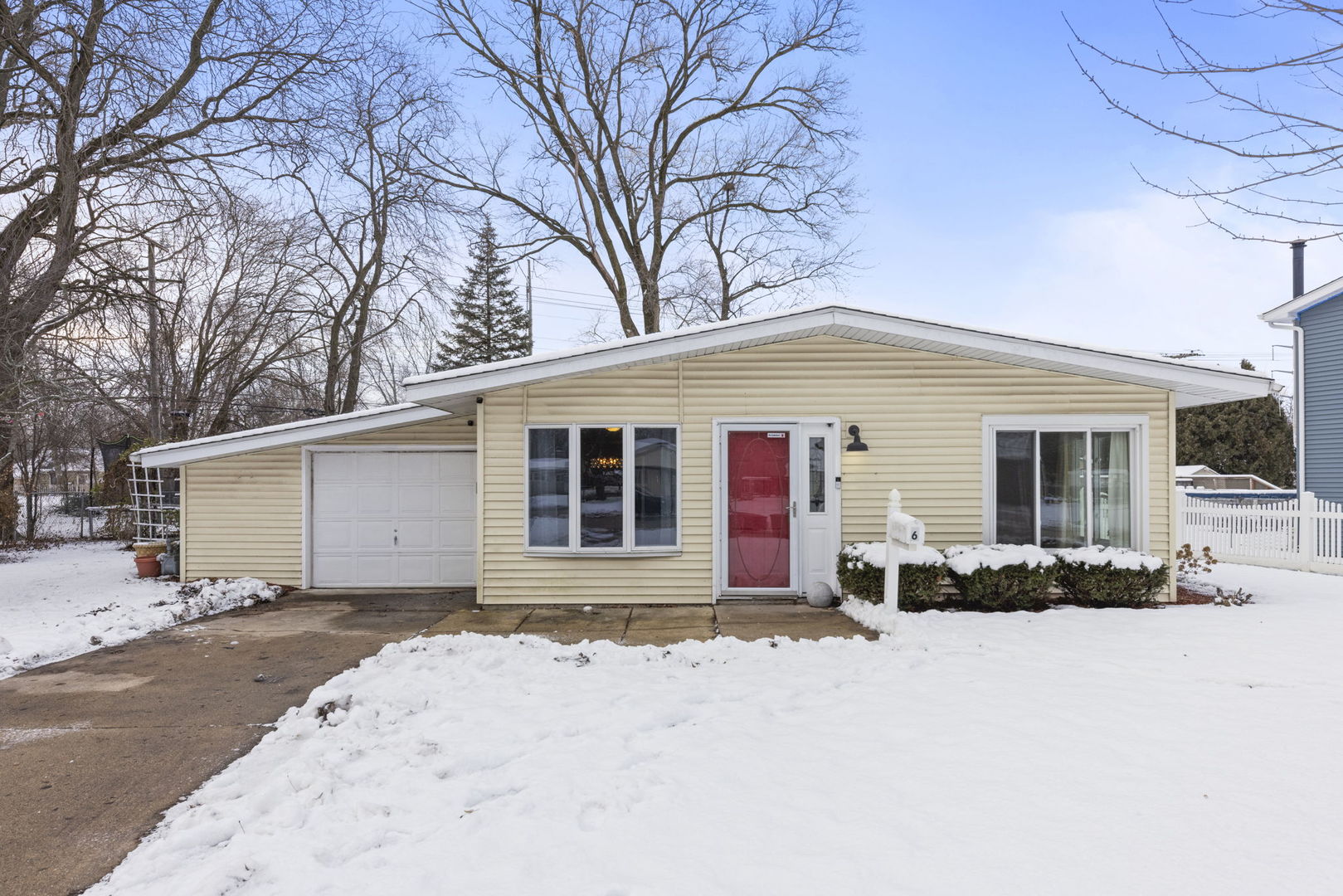 6 Saugatuck Road Montgomery, IL 60538 - Photo 1 of 25 a front view of a house with a yard covered in snow