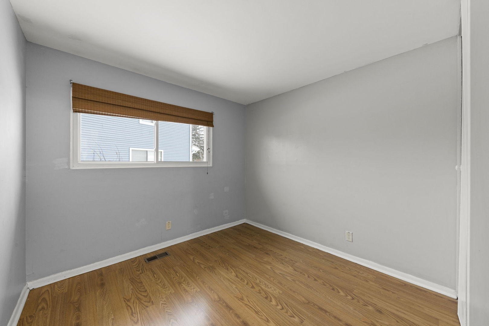6 Saugatuck Road Montgomery, IL 60538 - Photo 19 of 25 an empty room with wooden floor and windows