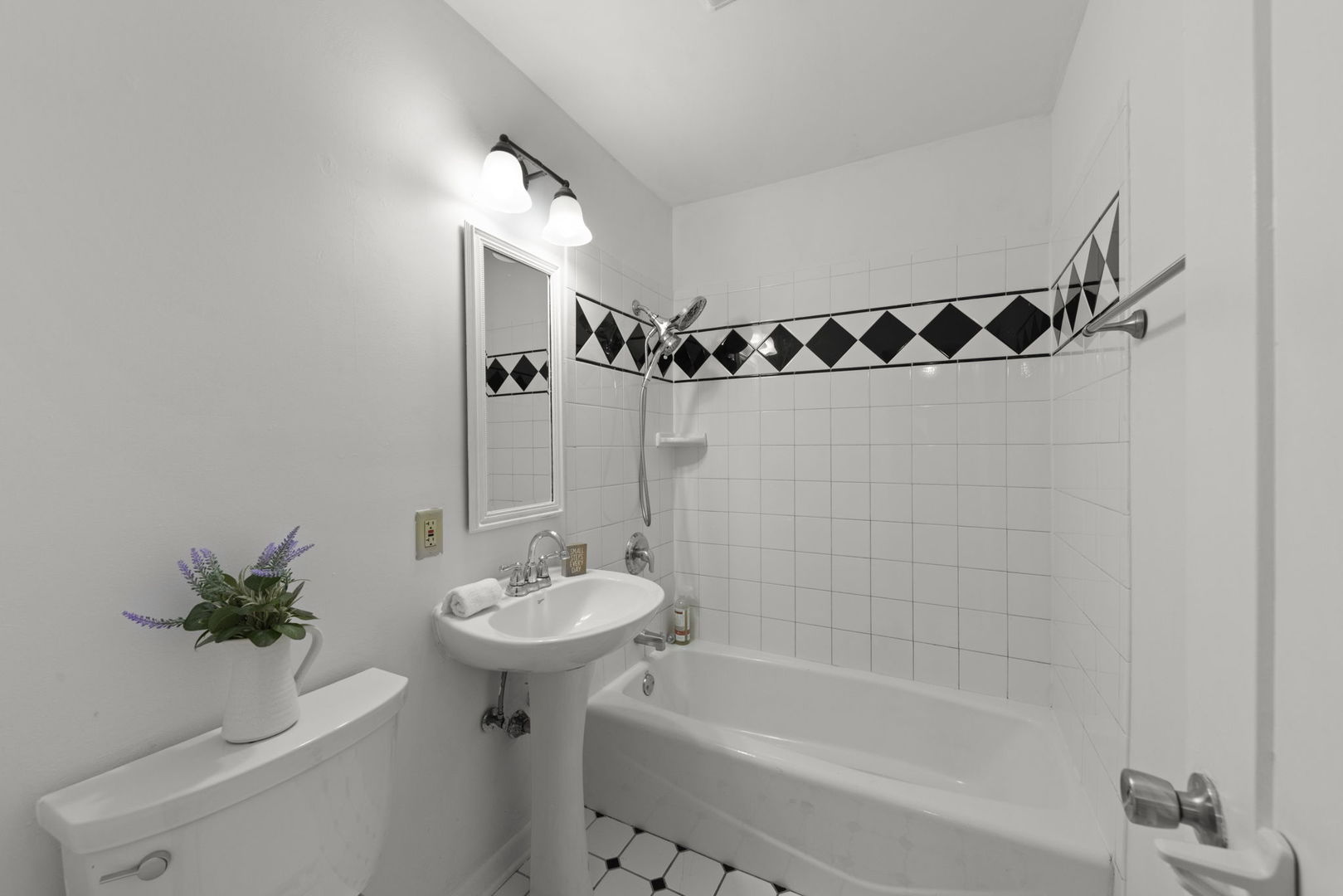 6 Saugatuck Road Montgomery, IL 60538 - Photo 20 of 25 a bathroom with a sink a mirror a bathtub and a shower