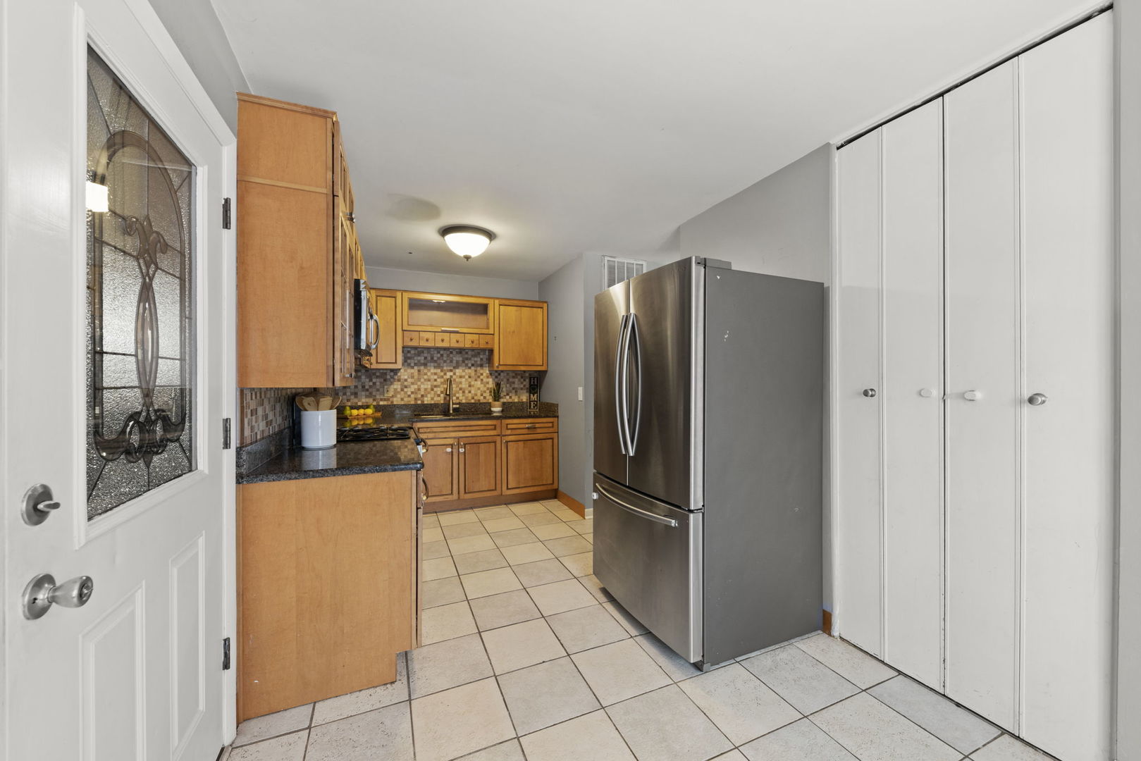 6 Saugatuck Road Montgomery, IL 60538 - Photo 10 of 25 a kitchen with stainless steel appliances a refrigerator and a stove top oven