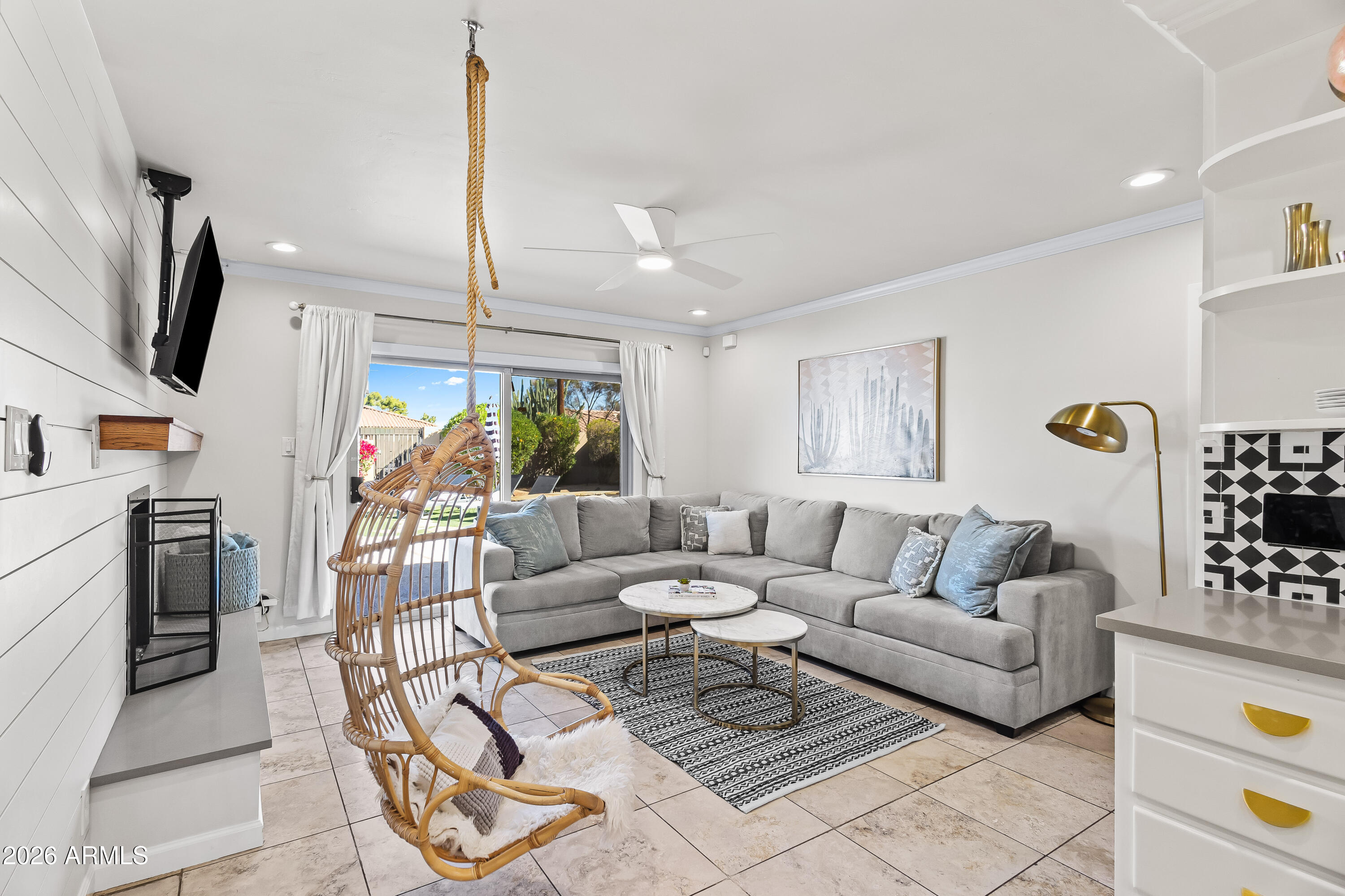 6810 East Granada Road Scottsdale, AZ 85257 - Photo 14 of 34 a living room with furniture a flat screen tv and a large window