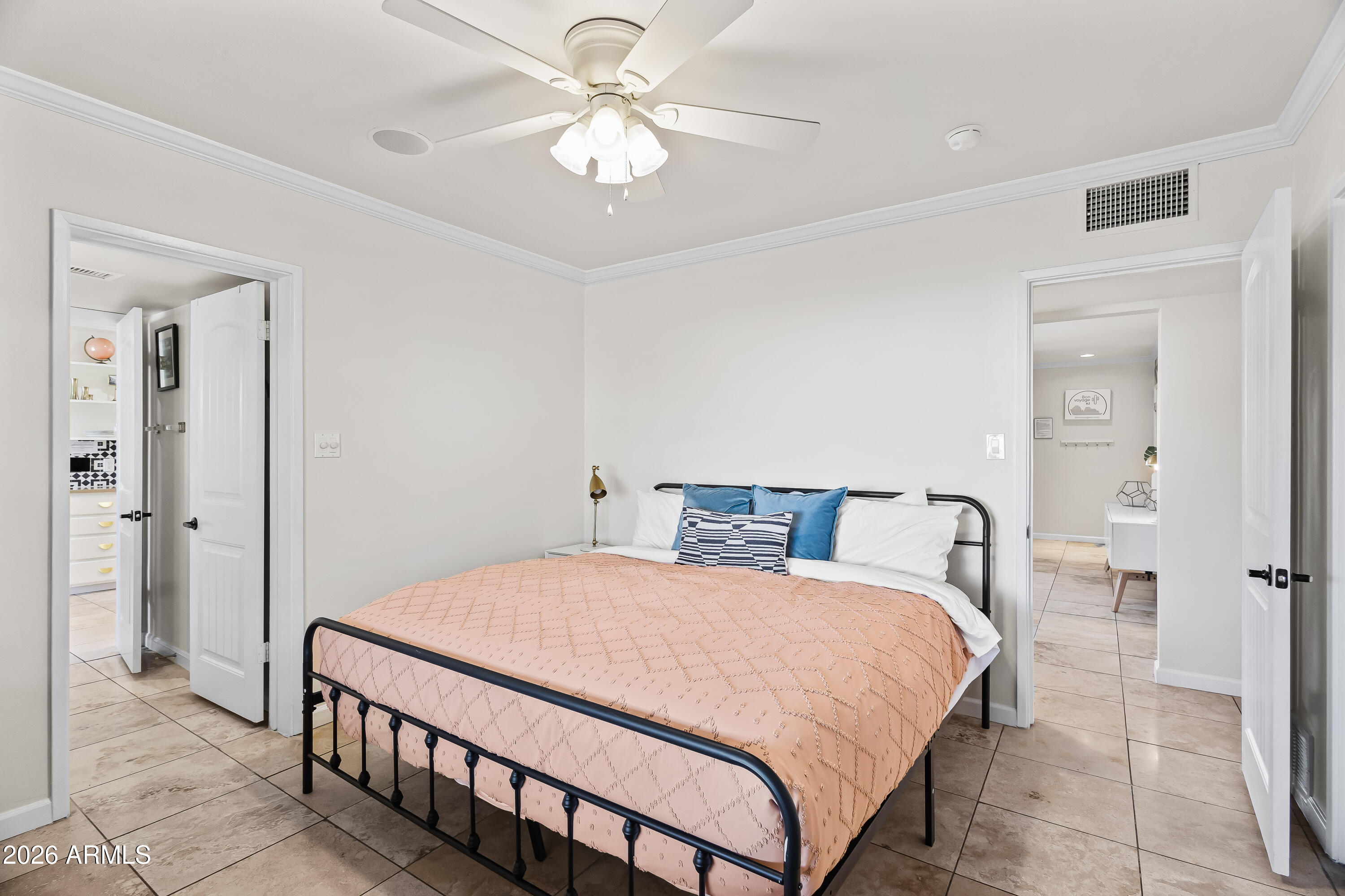 6810 East Granada Road Scottsdale, AZ 85257 - Photo 17 of 34 a bedroom with a bed and a chandelier