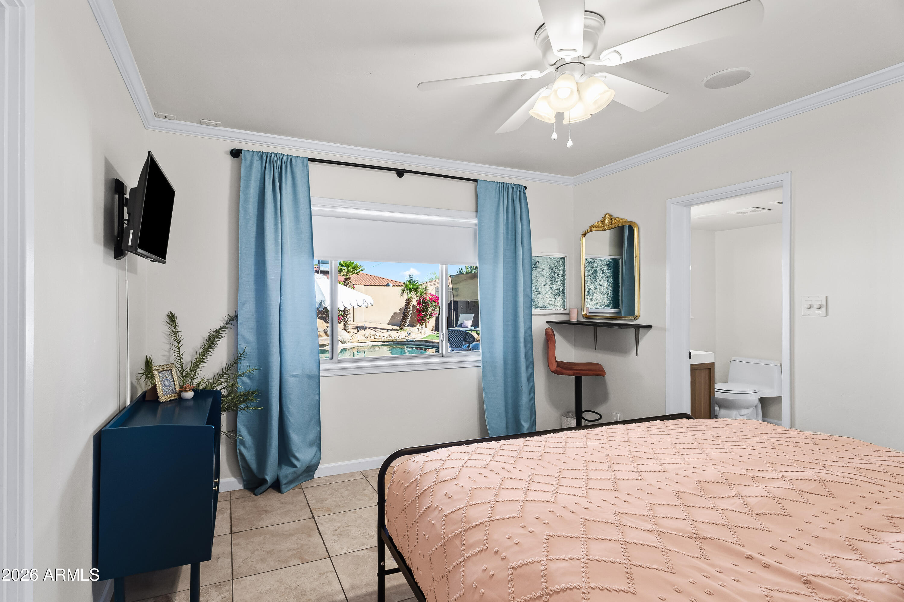 6810 East Granada Road Scottsdale, AZ 85257 - Photo 18 of 34 a bedroom with a bed and a television