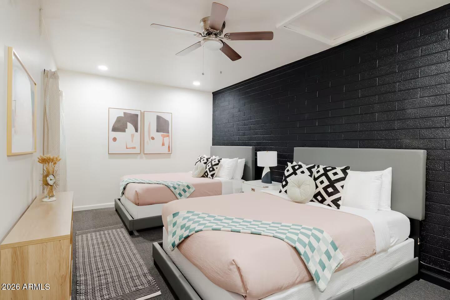 6810 East Granada Road Scottsdale, AZ 85257 - Photo 28 of 34 a spacious bedroom with two beds and a chandelier