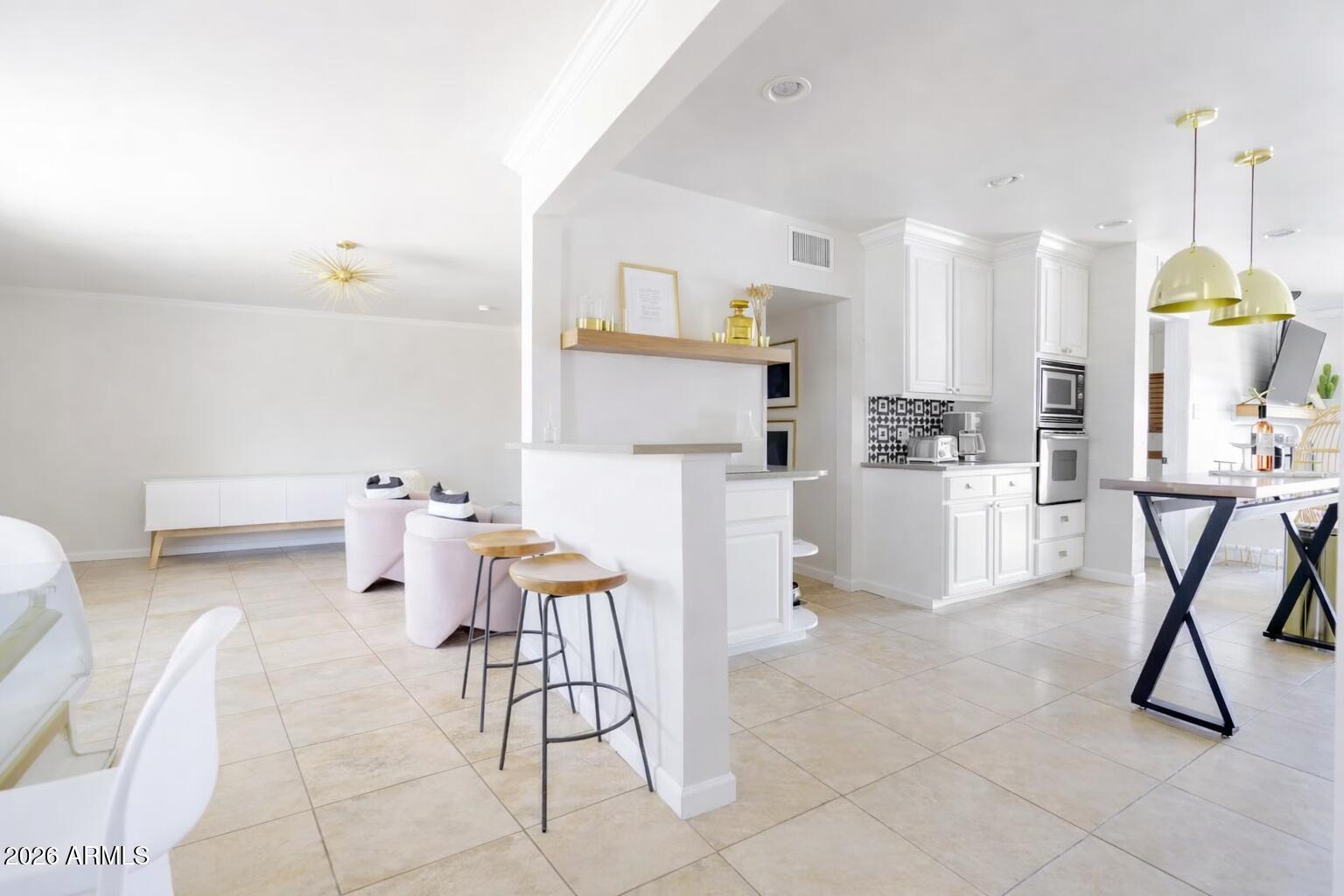 6810 East Granada Road Scottsdale, AZ 85257 - Photo 8 of 34 a living room with furniture a table and chairs