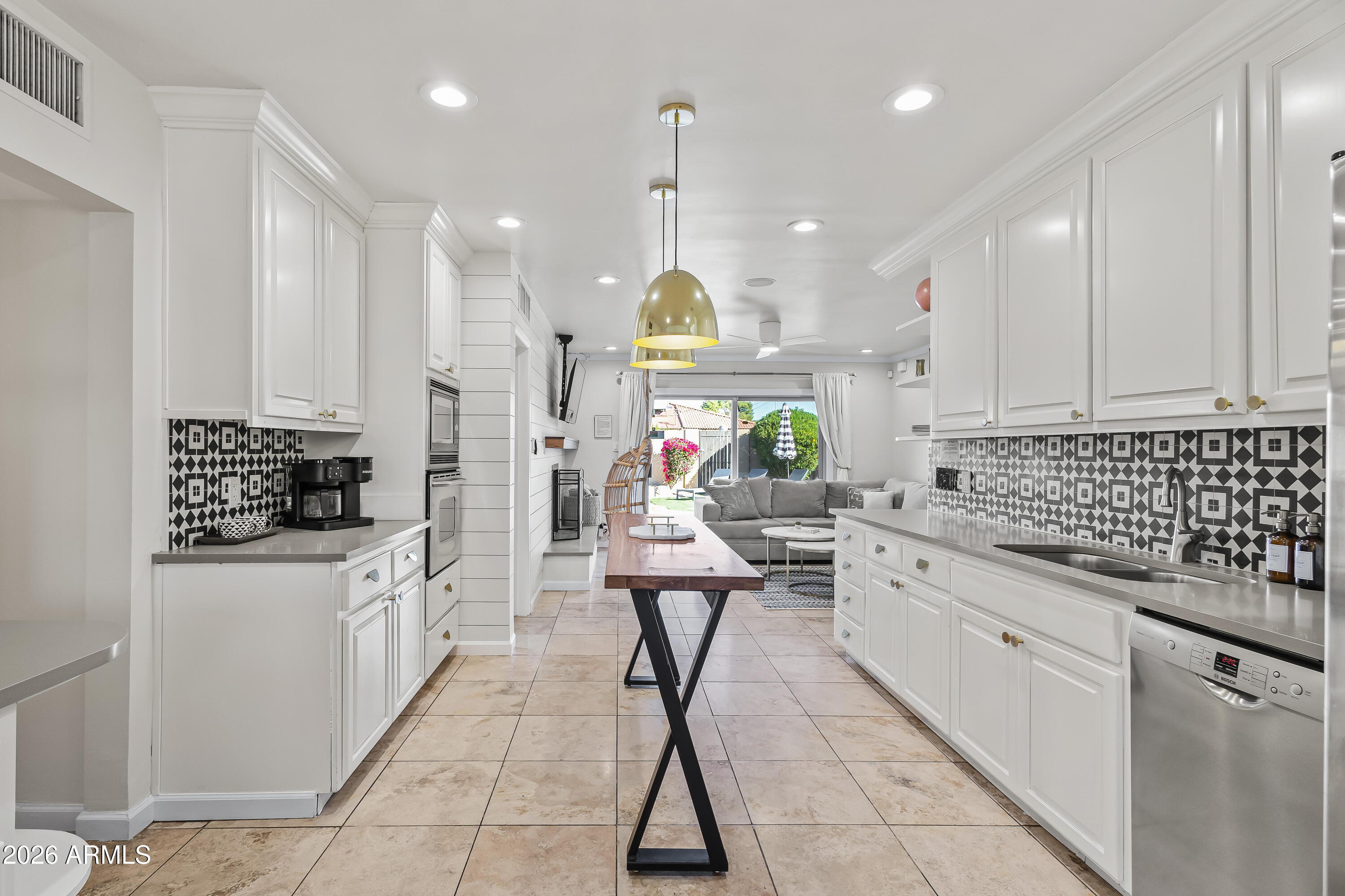 6810 East Granada Road Scottsdale, AZ 85257 - Photo 9 of 34 a kitchen with stainless steel appliances kitchen island granite countertop a stove a sink and a refrigerator