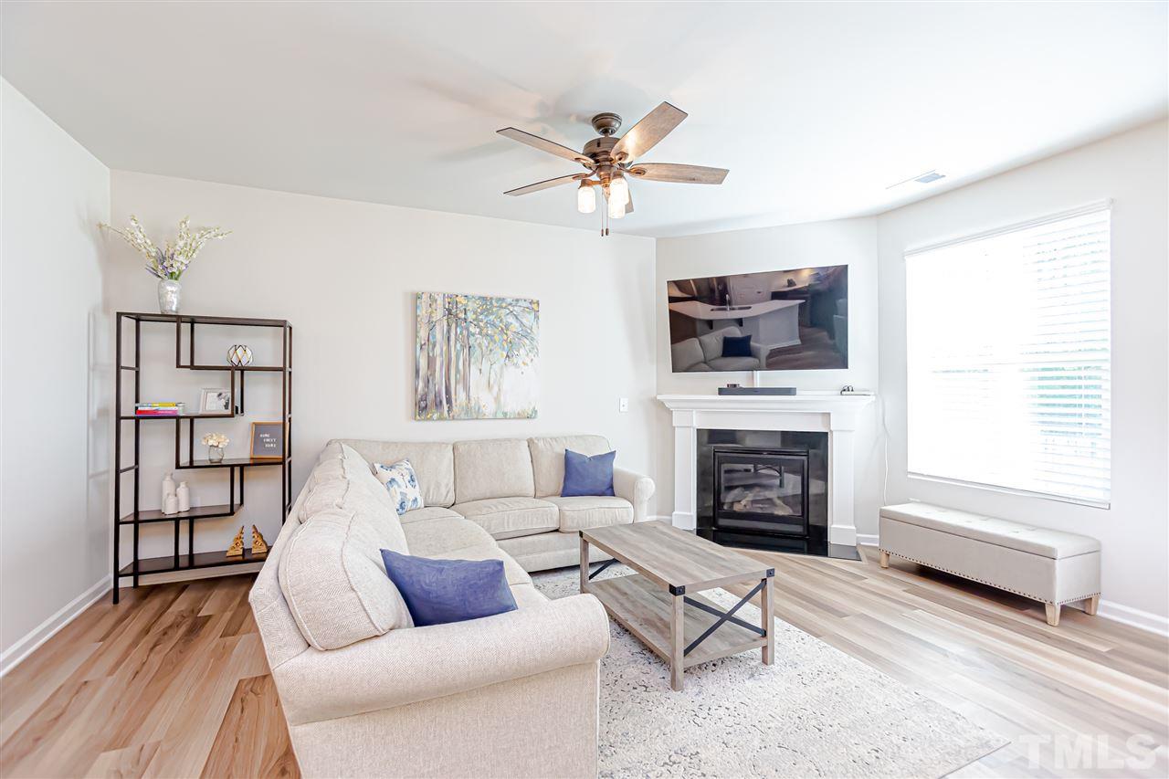 6123 Beale Loop Raleigh, NC 27616 - Photo 11 of 30 a living room with furniture a fireplace and a flat screen tv