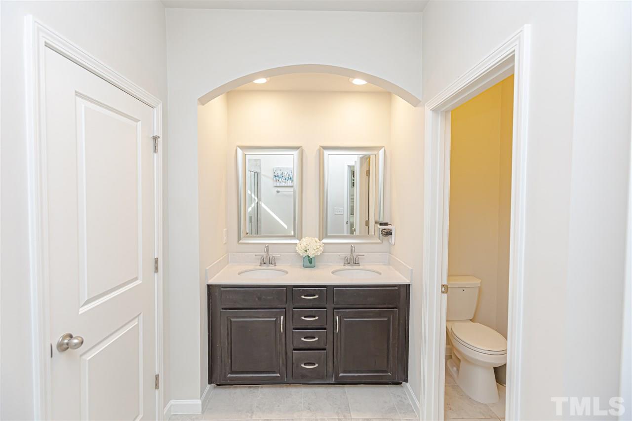 6123 Beale Loop Raleigh, NC 27616 - Photo 19 of 30 a bathroom with a granite countertop sink toilet and mirror