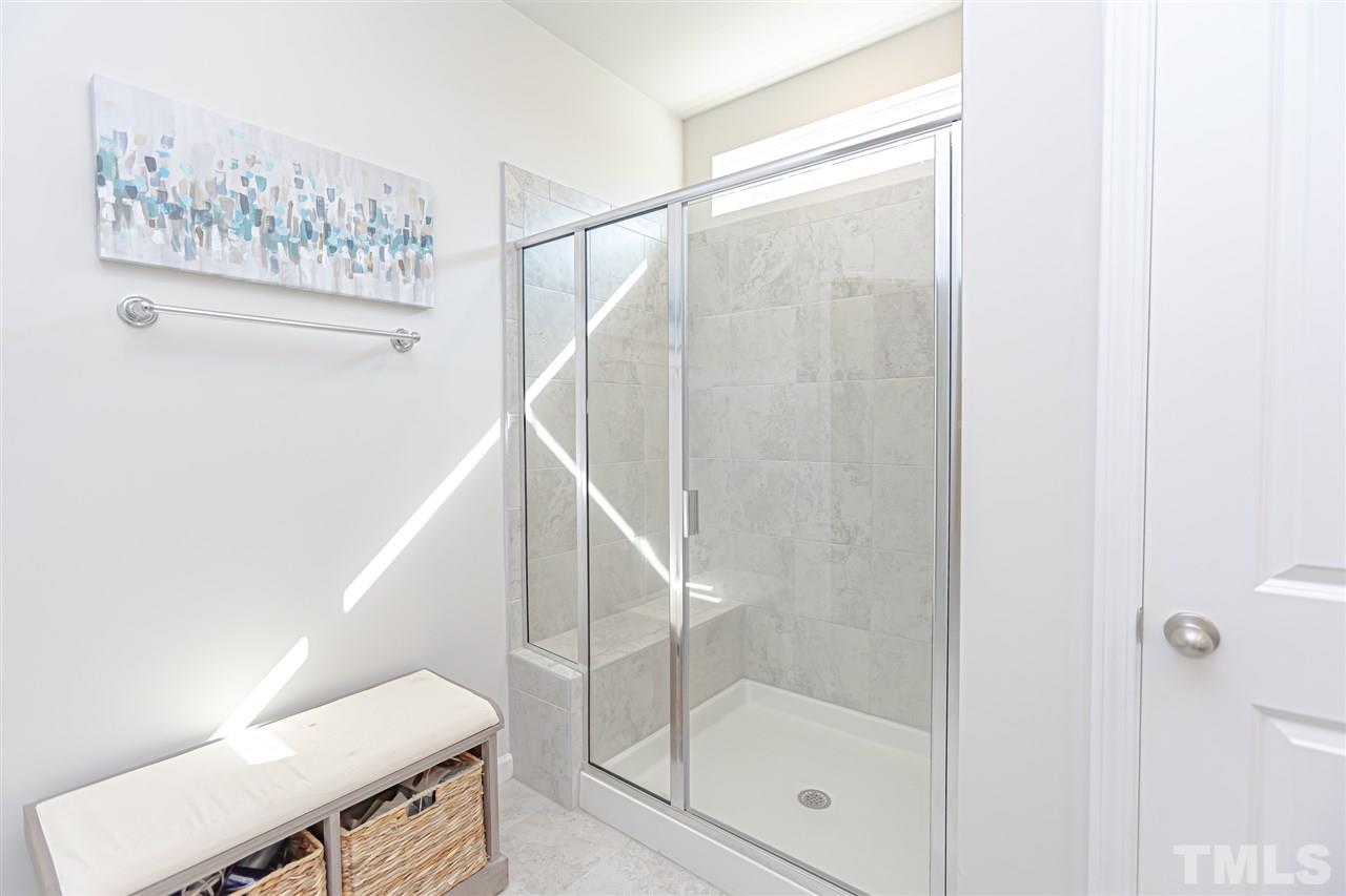 6123 Beale Loop Raleigh, NC 27616 - Photo 21 of 30 a bathroom with a glass shower door
