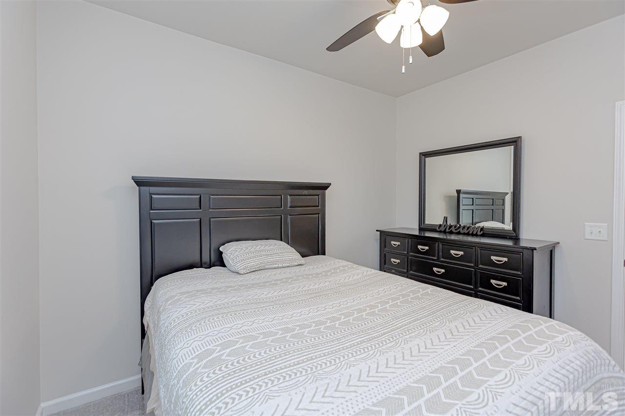 6123 Beale Loop Raleigh, NC 27616 - Photo 23 of 30 a bedroom with a bed and a dresser