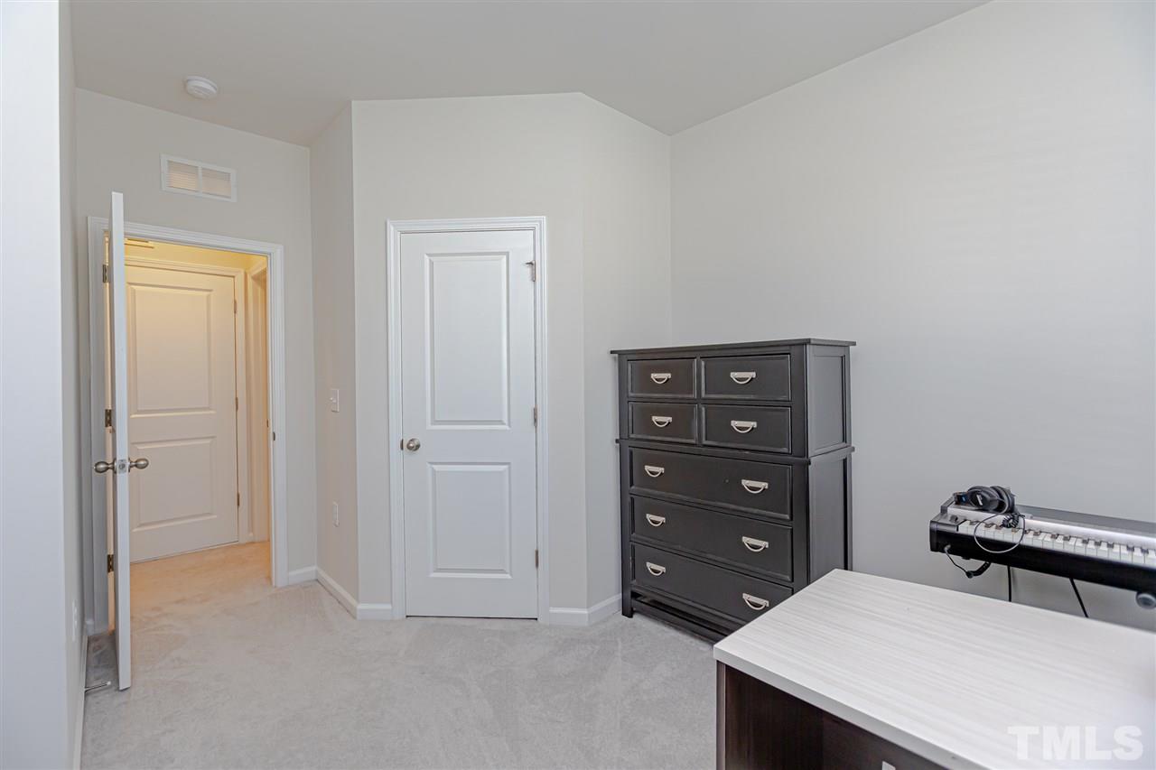 6123 Beale Loop Raleigh, NC 27616 - Photo 24 of 30 a bedroom with a bed and a closet