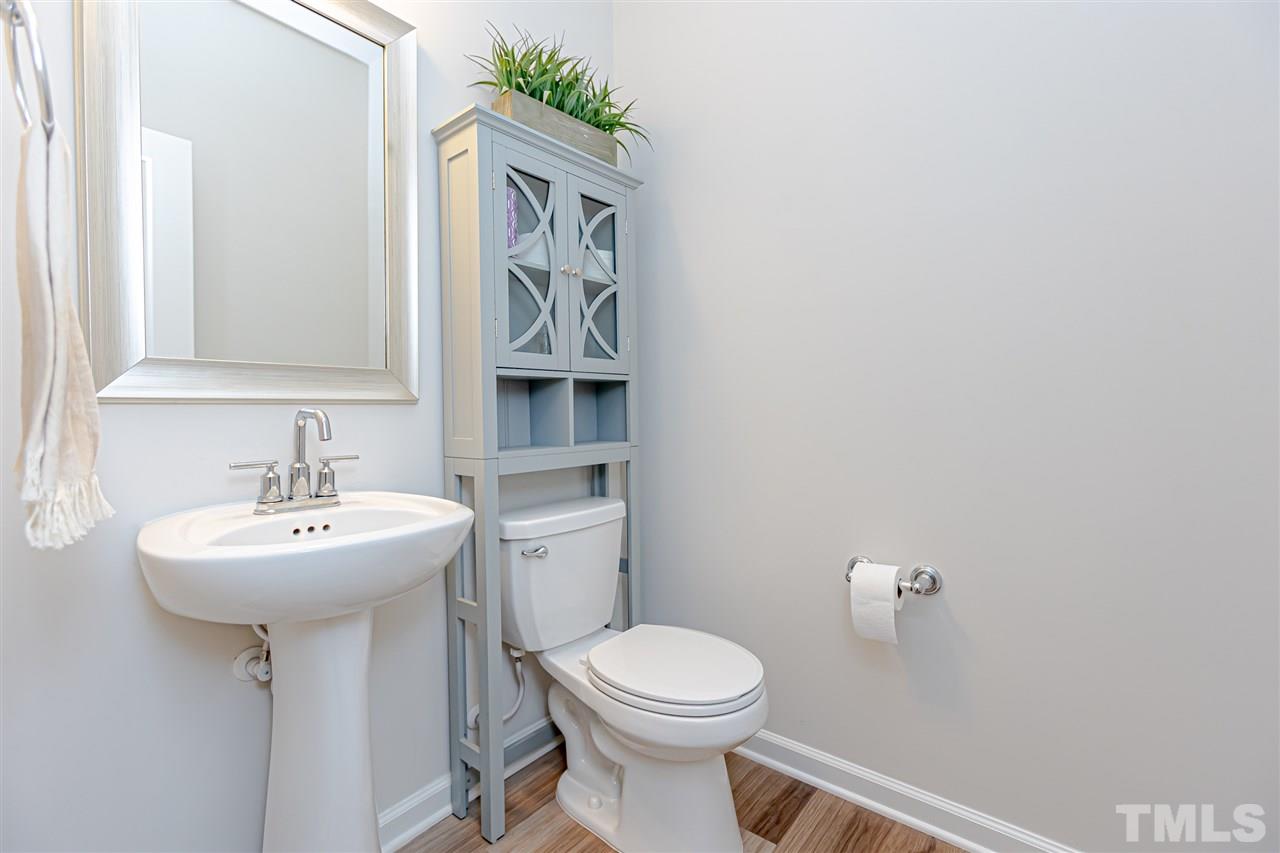 6123 Beale Loop Raleigh, NC 27616 - Photo 4 of 30 a bathroom with a sink mirror and toilet