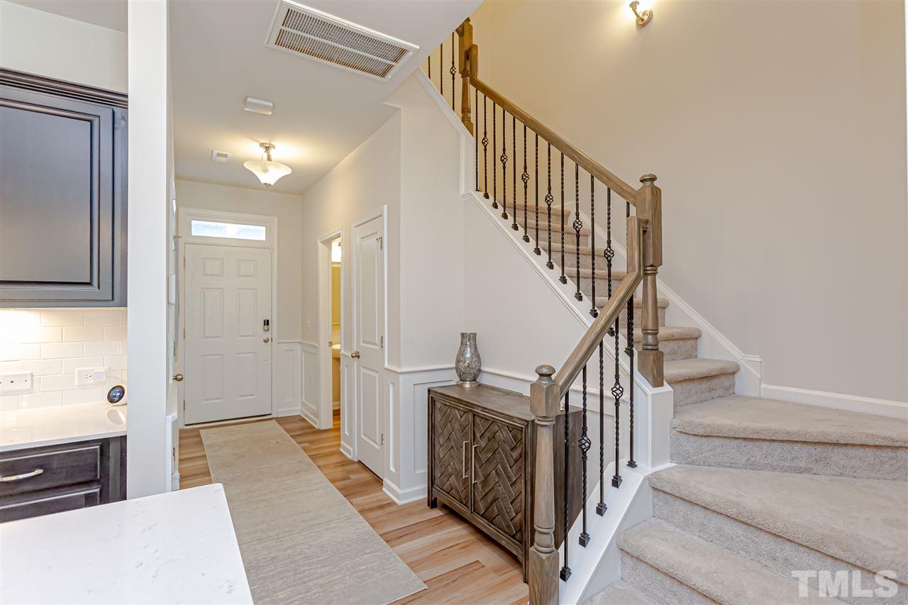 6123 Beale Loop Raleigh, NC 27616 - Photo 5 of 30 a view of a hallway with wooden floor and staircase