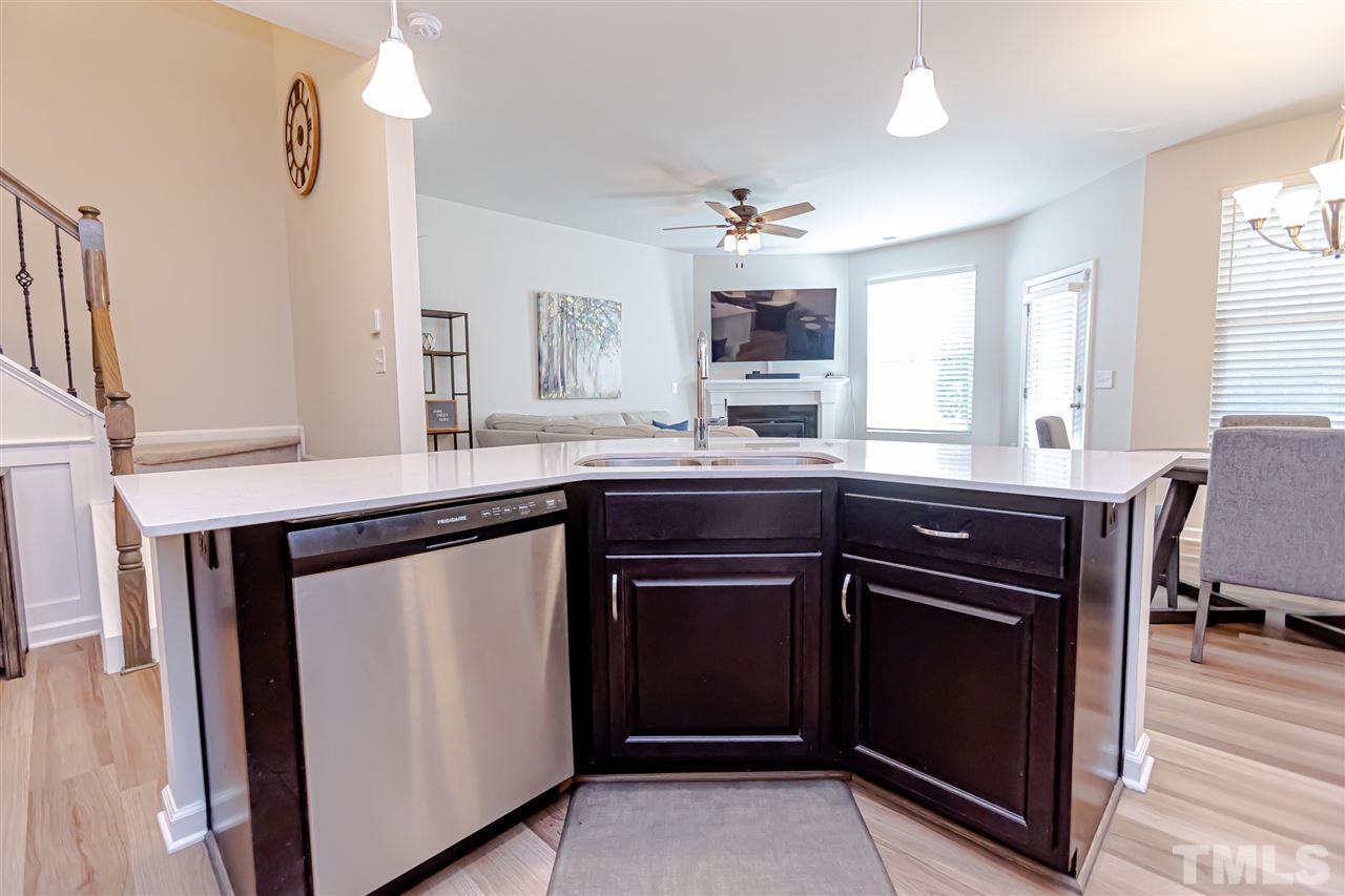 6123 Beale Loop Raleigh, NC 27616 - Photo 7 of 30 a kitchen with a sink and a refrigerator
