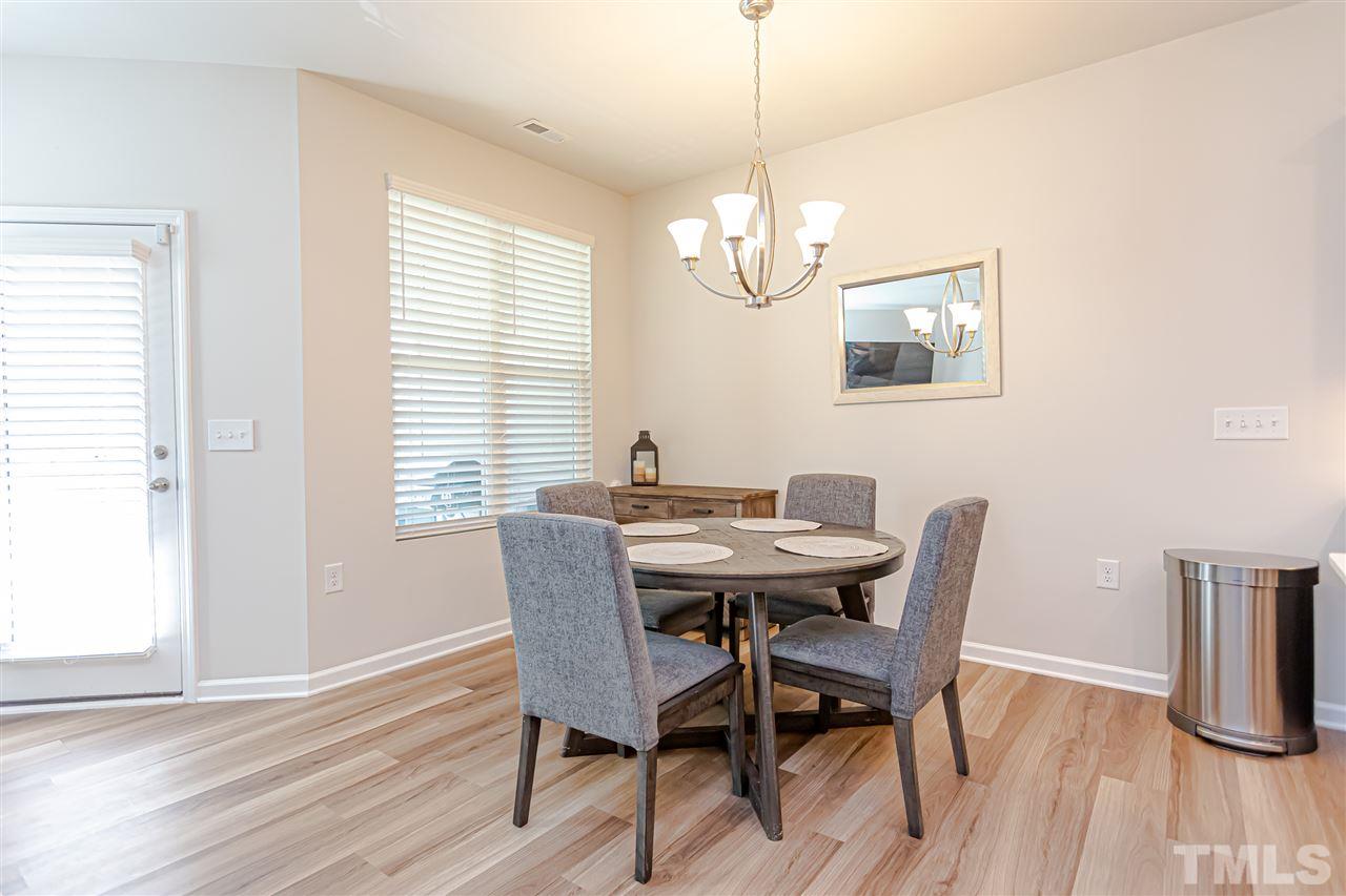 6123 Beale Loop Raleigh, NC 27616 - Photo 9 of 30 a view of a dining room with furniture window and wooden floor