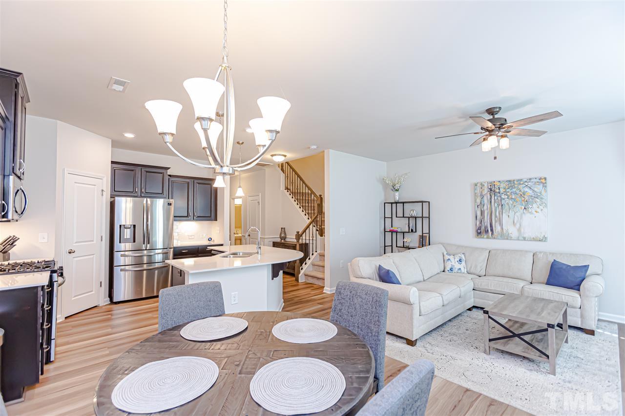 6123 Beale Loop Raleigh, NC 27616 - Photo 10 of 30 a living room with kitchen island furniture and a chandelier