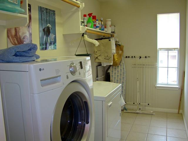 10700 Pointe View Drive Austin, TX 78738 - Photo 17 of 22 Laundry area with washing machine and clothes dryer and light tile patterned flooring