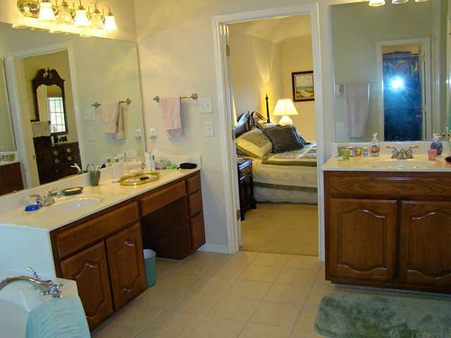 10700 Pointe View Drive Austin, TX 78738 - Photo 18 of 22 Bathroom featuring ensuite bath, two vanities, and light tile patterned floors