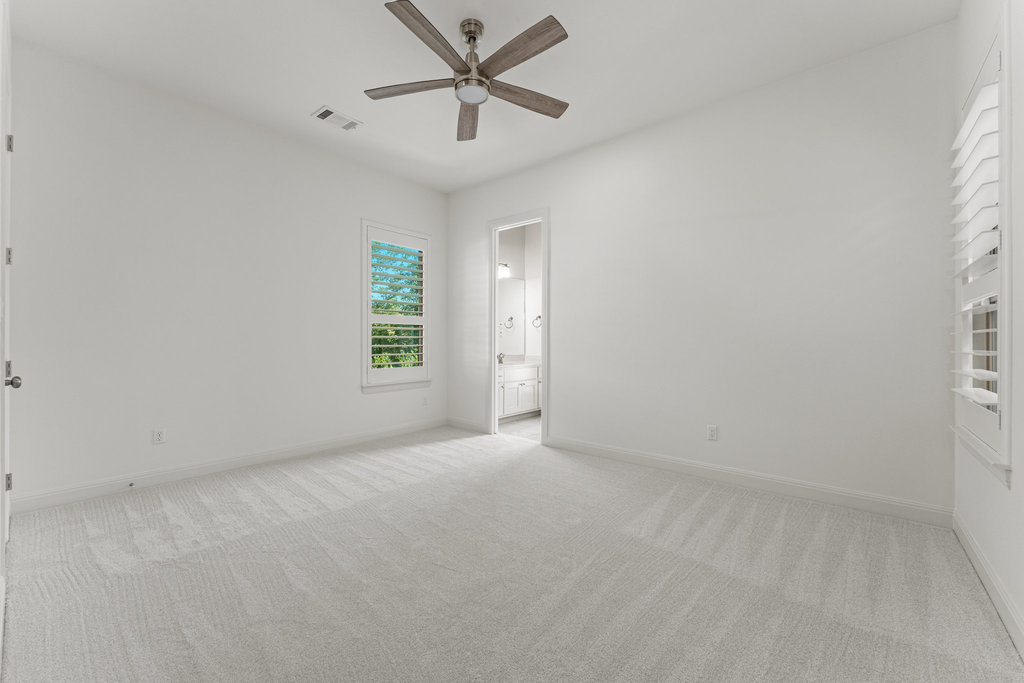 406 Woodside Terrace Austin, TX 78738 - Photo 17 of 34 Downstairs bedroom 2 with ensuite bathroom that opens to back patio