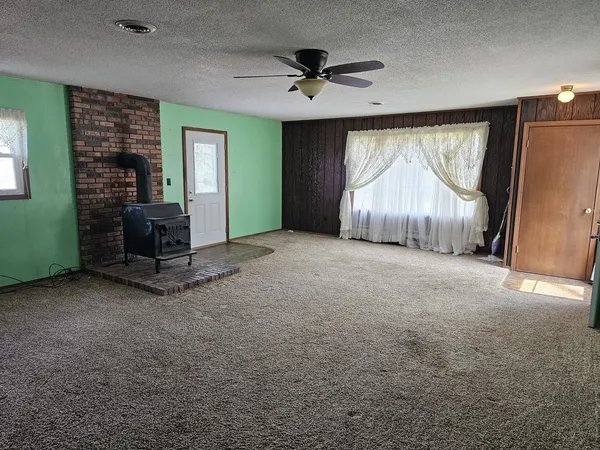 an empty room with windows and closet
