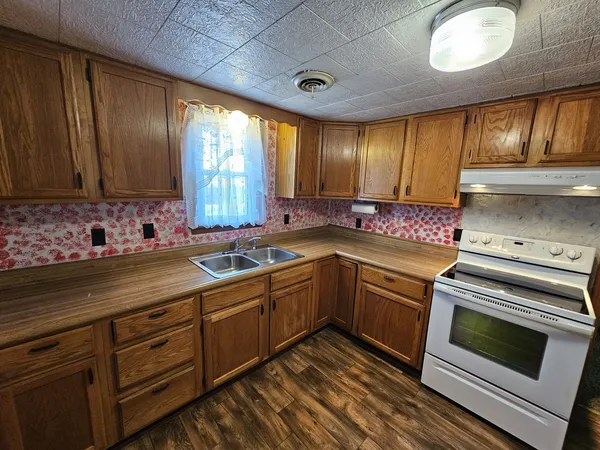 a kitchen with a sink stove and cabinets
