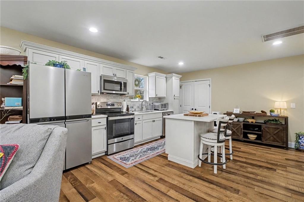 4843 Calhoun Road Northeast Rome, GA 30161 - Photo 21 of 56 a kitchen with a sink appliances and cabinets