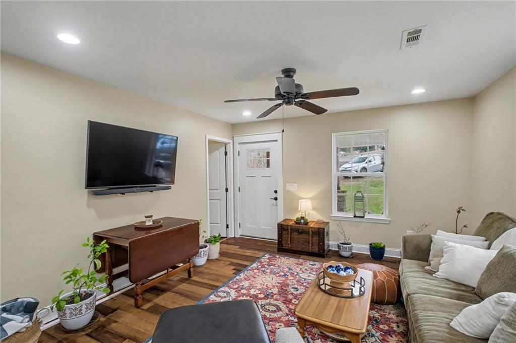 4843 Calhoun Road Northeast Rome, GA 30161 - Photo 23 of 56 a living room with furniture and a flat screen tv
