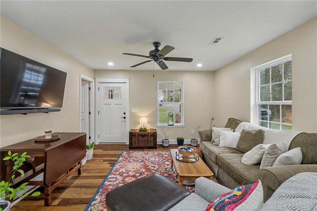 4843 Calhoun Road Northeast Rome, GA 30161 - Photo 25 of 56 a living room with furniture a flat screen tv and a window