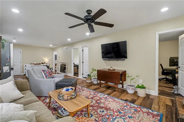 a living room with furniture and a ceiling fan