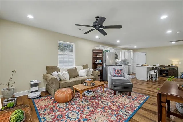 a bathroom with a sink a toilet a mirror and shower