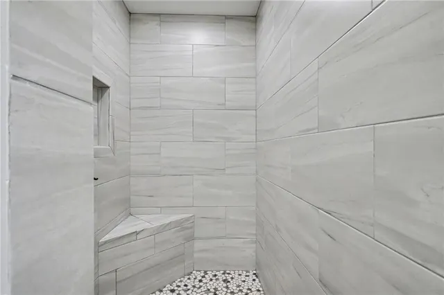 a bathroom with a granite countertop toilet a sink and bathtub