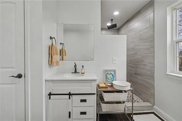 a bathroom with a sink a toilet and shower