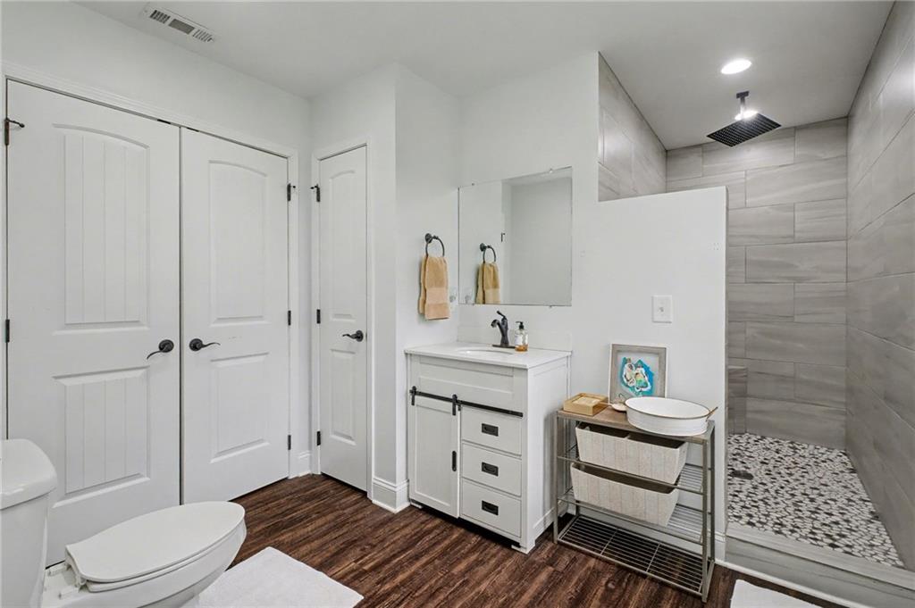 4843 Calhoun Road Northeast Rome, GA 30161 - Photo 42 of 56 a bathroom with a sink a toilet and shower
