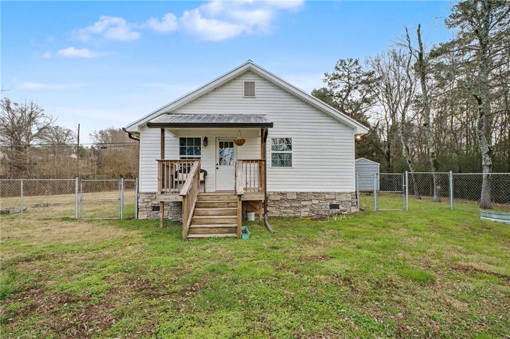 4843 Calhoun Road Northeast Rome, GA 30161 - Photo 47 of 56 a view of a house with a yard and sitting area