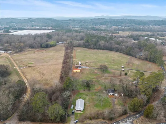 a view of a house with a yard and sitting area