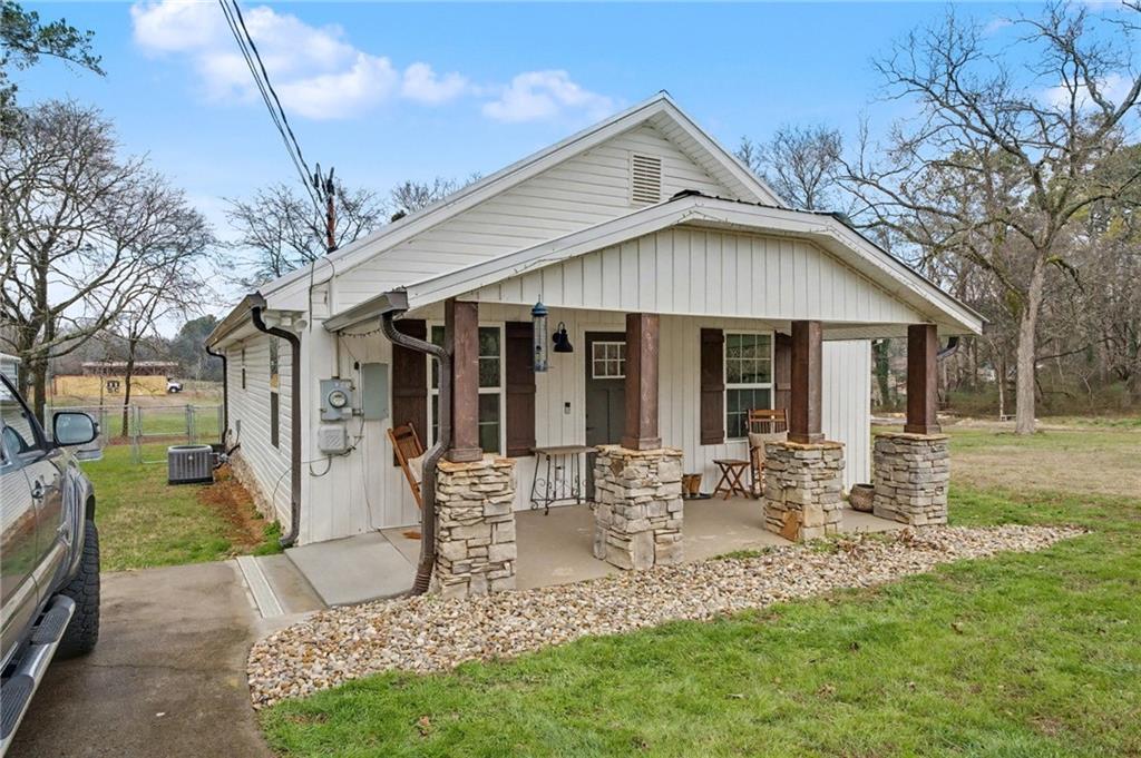 4843 Calhoun Road Northeast Rome, GA 30161 - Photo 5 of 56 a front view of house with a garden and patio