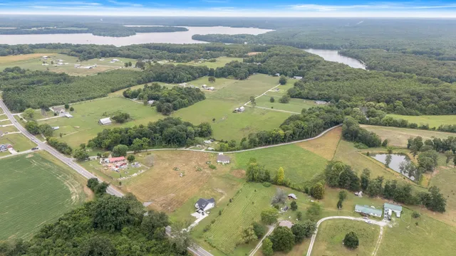 an aerial view of a house with a lake view